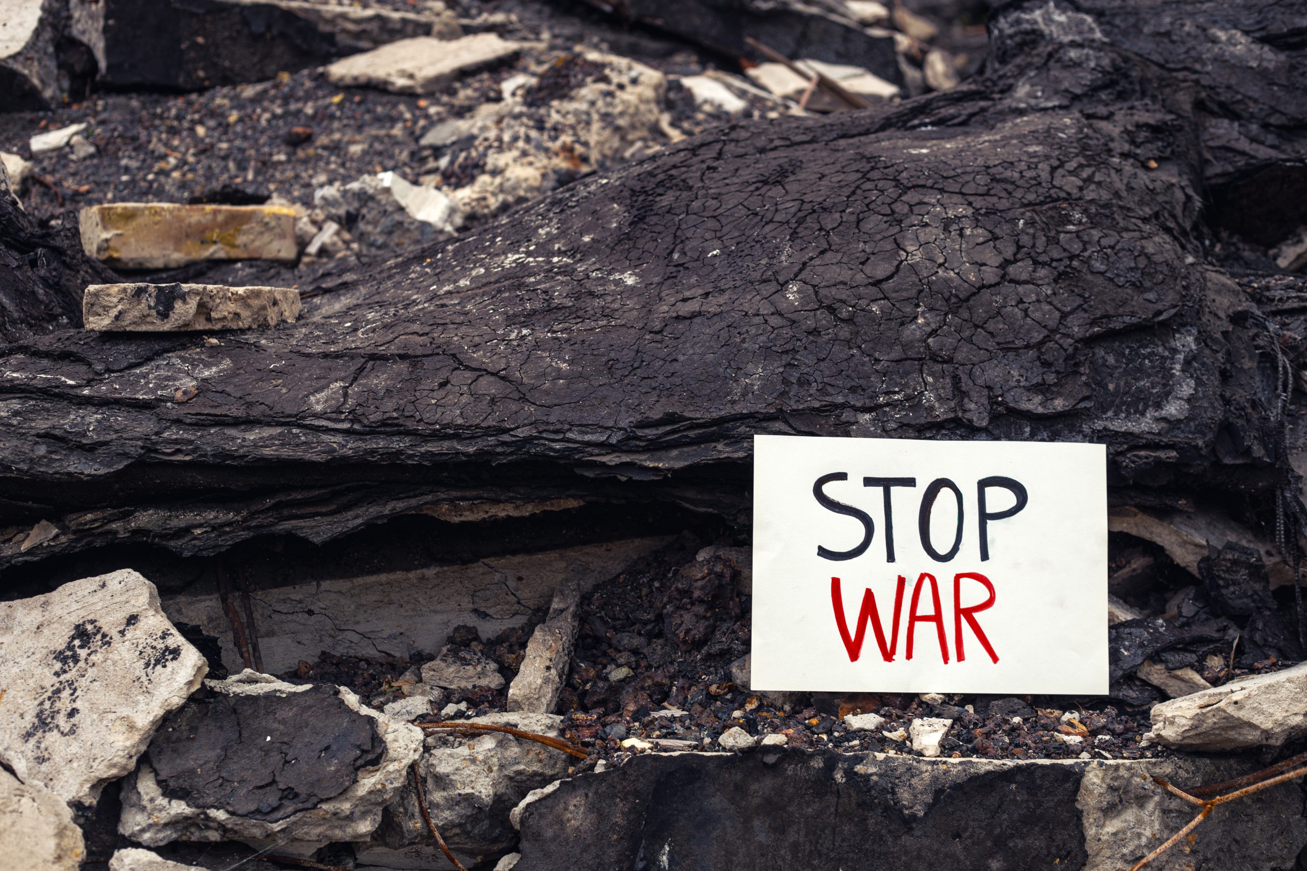 The inscription stop war. War in Ukraine. House destroyed by the war. High quality photo. The inscription stop the war on the background of ruins. Space for text.